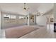 Spacious living room featuring tile floors, a fireplace, vaulted ceilings, and bright windows at 2313 E Gondola Ln, Gilbert, AZ 85234