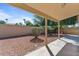 Private covered patio with stone landscaping and views of mature landscaping at 2313 E Gondola Ln, Gilbert, AZ 85234