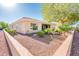 Expansive backyard featuring desert landscaping, mature trees, and a covered patio area perfect for outdoor living at 23216 N Gaviota Dr, Sun City West, AZ 85375