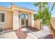 Backyard entrance featuring a sliding door, small patio, and red rock landscaping at 23216 N Gaviota Dr, Sun City West, AZ 85375