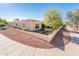 View of a backyard with a low wall, well-maintained landscaping and walking path at 23216 N Gaviota Dr, Sun City West, AZ 85375