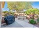 This backyard boasts a built-in firepit, grill, and lush tropical landscaping at 23216 N Gaviota Dr, Sun City West, AZ 85375