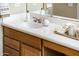 Bathroom sink with oak vanity cabinet, white countertop, and brushed nickel faucet at 23216 N Gaviota Dr, Sun City West, AZ 85375