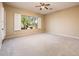 Bright bedroom with a large window offering outdoor views and a neutral color palette, perfect for relaxation at 23216 N Gaviota Dr, Sun City West, AZ 85375