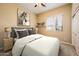 Comfortable bedroom with neutral tones, carpeted flooring, and a large window for natural lighting at 23216 N Gaviota Dr, Sun City West, AZ 85375