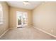 Neutral bedroom featuring plush carpet and walk-out patio with blinds at 23216 N Gaviota Dr, Sun City West, AZ 85375