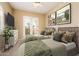 Bedroom with two beds, ceiling fan, dresser, and walk-out patio at 23216 N Gaviota Dr, Sun City West, AZ 85375