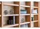 A bookshelf that is styled with books, geometric sphere decor, and plants at 23216 N Gaviota Dr, Sun City West, AZ 85375