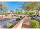 Manicured exterior grounds with walkway and low retaining wall at 23216 N Gaviota Dr, Sun City West, AZ 85375