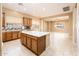 Open concept kitchen with wood cabinets, granite countertops, large center island, and an expansive view of the living area at 23216 N Gaviota Dr, Sun City West, AZ 85375