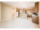 Spacious kitchen with wood cabinets, tiled floor, and a center island open to the breakfast and dining areas at 23216 N Gaviota Dr, Sun City West, AZ 85375