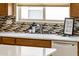 Kitchen sink features white countertops, a mosaic backsplash, and a stainless steel faucet at 23216 N Gaviota Dr, Sun City West, AZ 85375