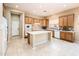 Inviting kitchen area complete with a functional center island, wooden cabinetry and modern appliances at 23216 N Gaviota Dr, Sun City West, AZ 85375