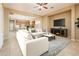 Open-concept living room featuring a fireplace, TV, and seamless transition to the kitchen at 23216 N Gaviota Dr, Sun City West, AZ 85375