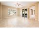 Light-filled living room with a ceiling fan and sliding doors to the outside at 23216 N Gaviota Dr, Sun City West, AZ 85375