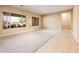 Spacious living room with plush carpeting and large windows showcasing outdoor views at 23216 N Gaviota Dr, Sun City West, AZ 85375