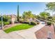 A nicely landscaped walking path winds through a quiet neighborhood on a bright day at 23216 N Gaviota Dr, Sun City West, AZ 85375