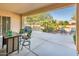 This covered patio showcases outdoor seating, a grill, and tranquil backyard views at 23216 N Gaviota Dr, Sun City West, AZ 85375