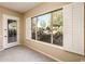 Bright room with a large window showcasing a beautifully landscaped backyard, ideal for enjoying nature and relaxation at 23216 N Gaviota Dr, Sun City West, AZ 85375