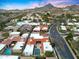 A captivating aerial shot captures a neighborhood's unique architecture, swimming pool, and landscaped yards at 2421 E Montebello Ave, Phoenix, AZ 85016