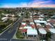 A scenic aerial view highlights well-designed homes, lush greenery, and a blue swimming pool in the neighborhood at 2421 E Montebello Ave, Phoenix, AZ 85016