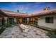 Spacious backyard with a fire pit, red tile roof, travertine tile, and lush landscaping at 2421 E Montebello Ave, Phoenix, AZ 85016