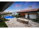 Luxury backyard with a pool, fire pit, travertine tile, and an outdoor seating area for entertaining at 2421 E Montebello Ave, Phoenix, AZ 85016