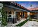 Charming backyard with a red tile roof, outdoor seating area with a heater, and manicured landscaping at 2421 E Montebello Ave, Phoenix, AZ 85016