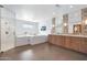 This elegant bathroom features a jacuzzi tub, walk-in shower, herringbone floors, and dual sink vanity at 2421 E Montebello Ave, Phoenix, AZ 85016