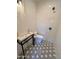 Compact bathroom with a standalone sink, a toilet, and shower with black and white hexagon tile flooring at 2421 E Montebello Ave, Phoenix, AZ 85016