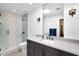 Bathroom showcasing modern fixtures, a glass-enclosed shower, and a stylish vanity mirror at 2421 E Montebello Ave, Phoenix, AZ 85016
