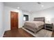 Bright bedroom features hardwood floors, a queen bed, and a view to the exterior at 2421 E Montebello Ave, Phoenix, AZ 85016
