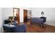 Comfortable bedroom featuring seating, hardwood flooring, and soothing decor at 2421 E Montebello Ave, Phoenix, AZ 85016