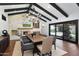 Charming dining room with a stone fireplace, built-in cabinetry, and a view to the outdoor patio at 2421 E Montebello Ave, Phoenix, AZ 85016