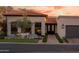 Attractive single-story home with a decorative front door, terracotta tile roof, and lush landscaping at 2421 E Montebello Ave, Phoenix, AZ 85016