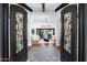 Inviting foyer with decorative tile flooring, wrought iron doors, and an elegant chandelier at 2421 E Montebello Ave, Phoenix, AZ 85016