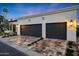 Spacious two-car garage with custom doors, manicured landscaping, and stylish outdoor lighting at 2421 E Montebello Ave, Phoenix, AZ 85016