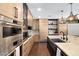 Well-lit kitchen with stainless steel appliances, modern cabinetry, and kitchen island at 2421 E Montebello Ave, Phoenix, AZ 85016