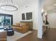Bright living room featuring hardwood floors, a modern light fixture, and sliding doors to the outdoor patio at 2421 E Montebello Ave, Phoenix, AZ 85016
