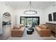 Spacious living room with hardwood flooring, modern lighting, neutral paint, and a view of the backyard at 2421 E Montebello Ave, Phoenix, AZ 85016