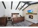 This spacious main bedroom features dark wood furnishings, a stone fireplace, and an elegant chandelier at 2421 E Montebello Ave, Phoenix, AZ 85016