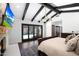This spacious main bedroom features wooden ceiling beams, stone fireplace, and a private access to the outside at 2421 E Montebello Ave, Phoenix, AZ 85016