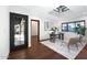 Bright home office with dark framed door, large windows, wooden desk and neutral color palette at 2421 E Montebello Ave, Phoenix, AZ 85016