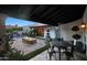 Outdoor patio with travertine pavers, firepit, and outdoor seating near pool and garden at 2421 E Montebello Ave, Phoenix, AZ 85016