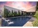 Sparkling pool with water feature set against landscaped grounds and picturesque twilight sky at 2421 E Montebello Ave, Phoenix, AZ 85016