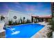 Resort style pool with tile water feature set in travertine decking and lush landscaping at 2421 E Montebello Ave, Phoenix, AZ 85016