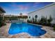 Beautiful backyard pool with a tile fountain feature, lush greenery, and travertine tile deck at 2421 E Montebello Ave, Phoenix, AZ 85016