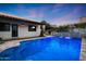 Inviting pool with travertine decking and water feature perfect for enjoying evenings and entertaining at 2421 E Montebello Ave, Phoenix, AZ 85016