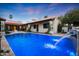 Inviting pool with travertine decking, water feature and outdoor BBQ area, perfect for outdoor living at 2421 E Montebello Ave, Phoenix, AZ 85016