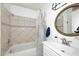 Classic bathroom with a shower-tub combo, decorative tiles, and a modern sink and vanity at 2424 E Aster Dr, Phoenix, AZ 85032